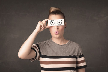 Funny woman looking with hand drawn paper eyes