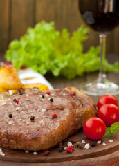 Tenderloin steak with potatoes and cherry tomatoes, vertical
