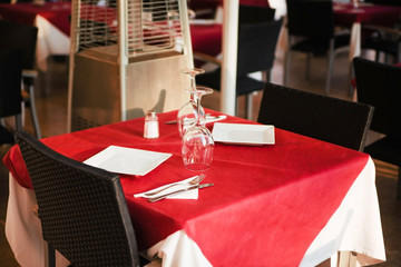 Street view of a cafe terrace with empty tables and chairs