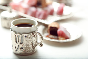 Antique tea-set with Turkish delight on table close-up