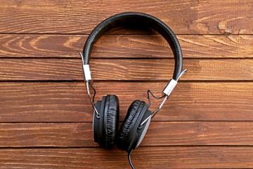 Headphones on brown wooden background