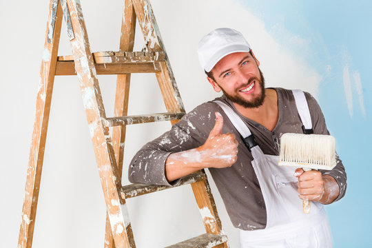 painter in white dungarees with thumbs up gesture