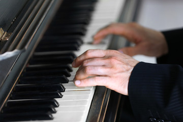 Fototapeta na wymiar Close up of man hands piano playing