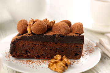 Piece of chocolate cake with walnut on the table, close-up