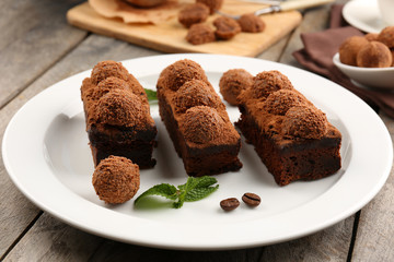 Pieces of chocolate cake with mint on the table, close-up