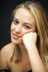 Portrait of Beautiful Young Woman  resting her face in her hand