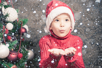 Little boy fairy blowing fairy magical glitter, stardust at Christmas