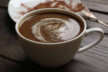 Cup of coffee with kisses on wooden background