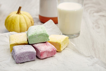 Breakfast with colored marshmallows pumpkin milk and yogurt on w