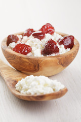 cottage cheese with preserved strawberry on blue table