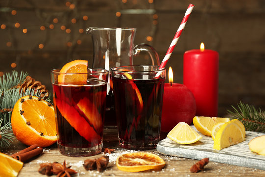 Decorated composition of mulled wine in glasses on wooden table