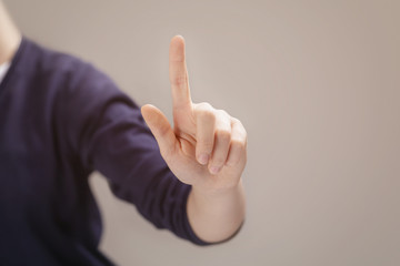 young female hand to select or touch something on transparent screen