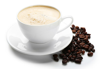 A cup of tasty drink and scattered coffee grains, isolated on white