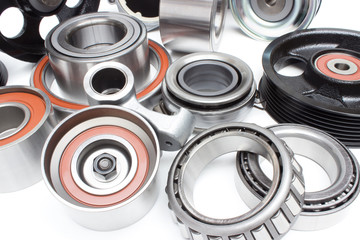 located on a white background variety of bearings and rollers wide range of applications, from automotive hub to engine belt tensioners