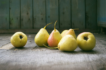 Yellow pears on wooden floor, still life