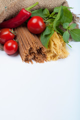 Italian pasta. Spaghetti with tomatoes and sharp pepper in a sack isolated on white background