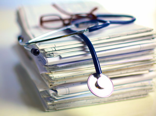 books folder file and stethoscope isolated on white background