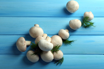 Mushrooms on color wooden surface