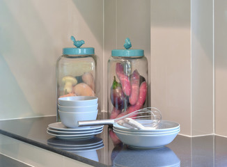 modern ceramic kitchenware and utensils on the black granite counter