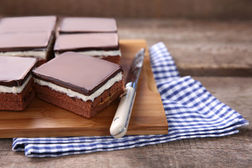 Delicious chocolate brownies on wooden background