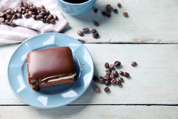 Delicious chocolate brownie on plate on wooden background