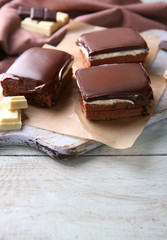 Delicious chocolate brownies on wooden background