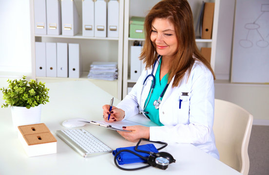 Portrait of happy medical doctor woman in office