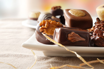 Assorted bonbons in a white dish close up front view