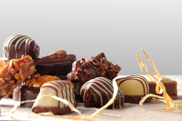 Group of bonbons stacked on tablecloth fabric with gray backgrou