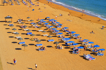 Fototapeta na wymiar Albufeira, Algarve, Portugal - October 26, 2015 : People enjoying the sun on Albufeira Beach