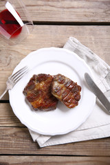 Roasted beef fillet on plate, on wooden background