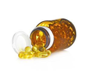 Fish oil capsules and container on white background
