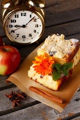 Top view on apple cake with alarm clocks