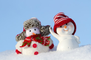 two Snowmen in clothing are next