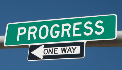 Progress printed on green overhead highway sign with one way arrow 