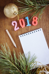 Bright background with blank notepad about Happy New Year holiday  2018