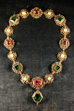 Antique jewelry golden chain with large precious gems.