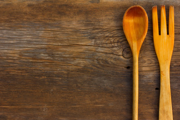 Old texture cracked background barn boards and wooden spoon and fork. The concept of rustic kitchen. Top view. Free space for text. Copy space
