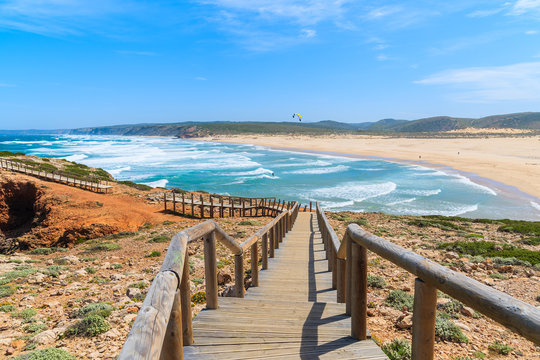 Wooden walkway to Praia do Bordeira beach and beautiful blue sea view, Algarve region, Portugal