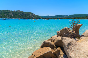 Fototapeta na wymiar Rocks and crystal clear turquoise sea water of Santa Giulia beach, Corsica island, France