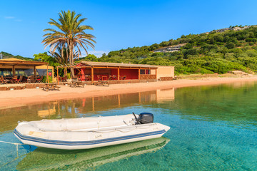 Fototapeta na wymiar Dinghy boat on Santa Manza beach, Corsica island, France