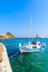 White and blue color Greek fishing boat mooring in Kokkari port, Samos island, Greece