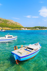 Fototapeta na wymiar Greek fishing boats on turquoise sea water in Posidonio bay, Samos island, Greece