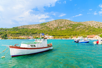 Traditional Greek fishing boat on turquoise sea water in Posidonio bay, Samos island, Greece