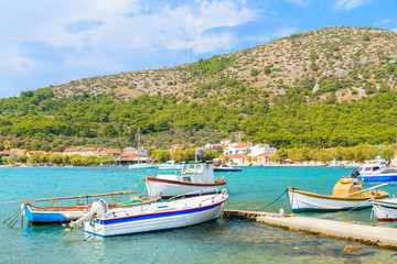 Fototapeta na wymiar Colorful Greek fishing boats on shore in Posidonio bay, Samos island, Greece