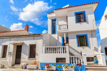 Typical Greek houses with flower pots in front in Kokkari town on coast of Samos island, Greece