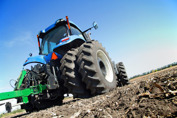 Farmer on a tractor plowed field