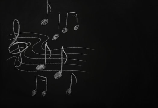 A blackboard with musical notes on the wall in the classroom