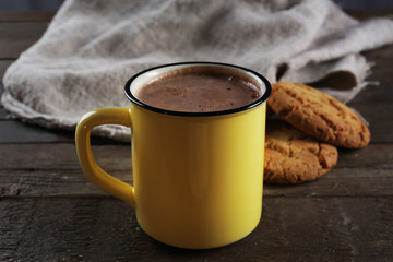 Tasty cocoa in metal old-fashioned mug and marshmallow on the table