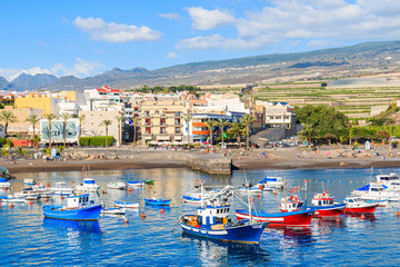 Fototapeta na wymiar Traditional fishing boats in San Juan port with mountains in background, Tenerife, Canary Islands, Spain